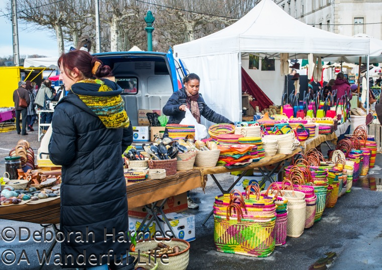 Market stall selling straw goods in France.